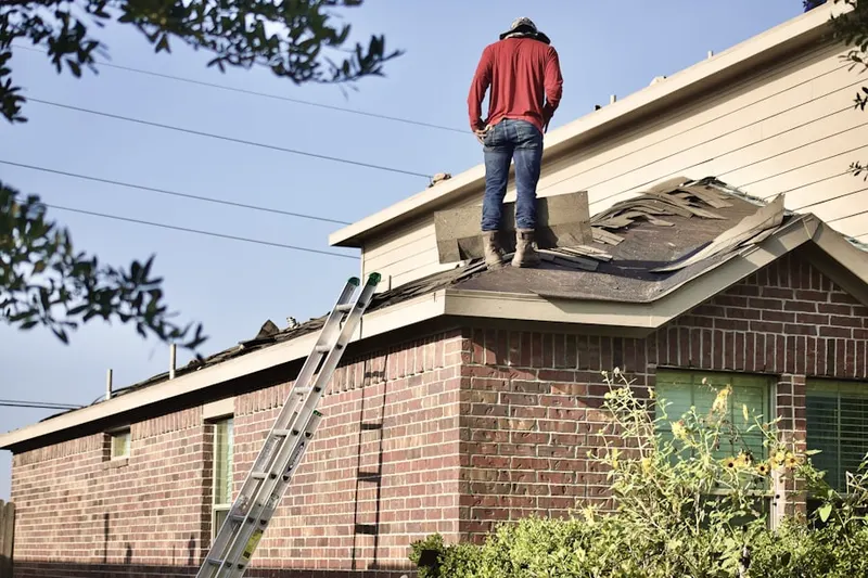 Professional roofer working on a residential roof in Yadkinville